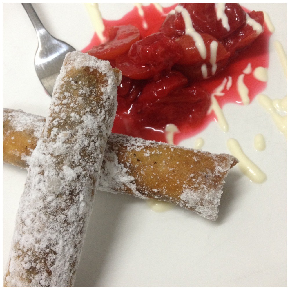 Fith course "Chocolate spring rolls with stewed plums"